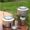 Pure titanium kettle tea set displayed outdoors with cups and a small container.