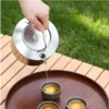1L pure titanium kettle with lid placed on a portable camping stove.