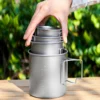TA1 titanium folding handle mugs in nested sizes being placed into the largest mug for compact storage.