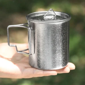 Handheld pure titanium camp mug with crystalline finish outdoors