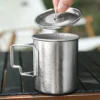 Pure titanium camp mug with lid lifted and crystalline finish