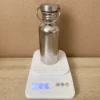 TiRoam 500ml single-wall pure titanium water bottle on a digital scale showing about 122g weight