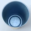 Interior view of a blue TiRoam titanium cup showing smooth titanium surface and drinkware detail