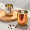 TiRoam gold and silver titanium tumblers with iced drinks, double-wall pure titanium cups for tea, coffee, and cold beverages