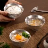 TiRoam pure titanium rice bowls with rice and side dishes on a dining table, lightweight titanium dinnerware for everyday meals and clean-tasting food.
