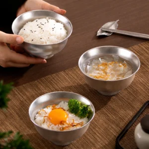 TiRoam pure titanium rice bowls with rice and side dishes on a dining table, lightweight titanium dinnerware for everyday meals and clean-tasting food.