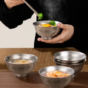 TiRoam pure titanium bowl holding a hot rice meal with steam, durable lightweight titanium bowl for warm food, home dining, camping, and outdoor meals.