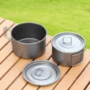 TiRoam titanium camping pot cookware set with lid and folding handle on an outdoor table, lightweight titanium gear for camping and backpacking.