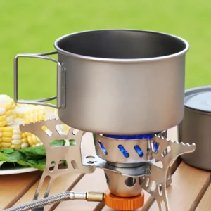 TiRoam titanium camping pot heating on a portable camp stove, lightweight outdoor cookware for camping meals, backpacking, and picnic cooking.