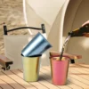 Colorful TiRoam titanium cups on a camping table with drink being poured, lightweight outdoor titanium drinkware