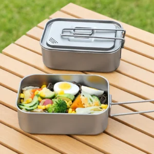 TiRoam titanium lunch box set with lid and folding handle, filled with a fresh outdoor meal on a wooden camping table for picnics, camping, and travel.