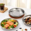 TiRoam pure titanium plates with fresh salad, nuts, and snacks on a bright table, lightweight reusable plates for healthy meals, camping, and everyday dining.