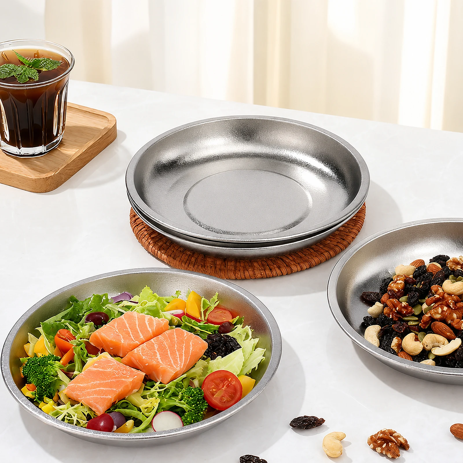 TiRoam pure titanium plates with fresh salad, nuts, and snacks on a bright table, lightweight reusable plates for healthy meals, camping, and everyday dining.