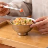 TiRoam titanium rice bowl filled with fried rice, lightweight reusable bowl for everyday dining, meal prep, camping meals, and outdoor food use.
