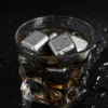 TiRoam titanium whiskey stones inside a whiskey glass, reusable drink chilling cubes for bourbon, cocktails, spirits, and cold beverages.
