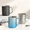 Product photograph of an insulated crystal titanium travel mug with a modern metallic crystalline pattern against a clean background.