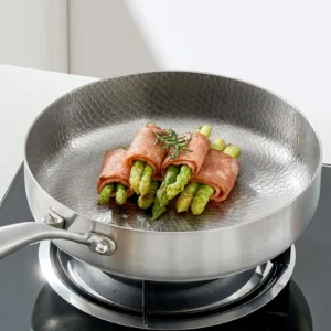 Titanium frying pan cooking bacon-wrapped asparagus
