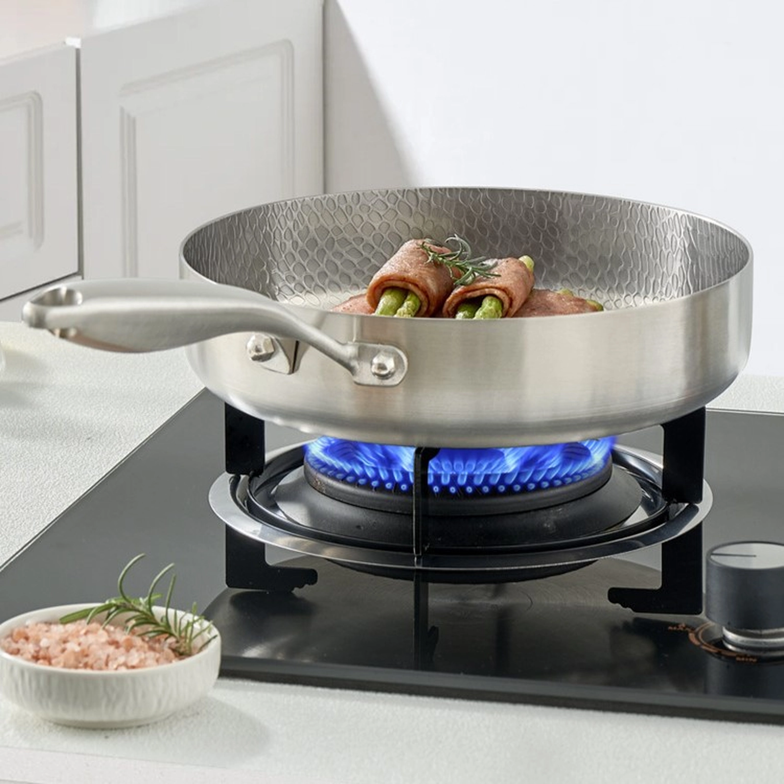 Titanium frying pan cooking on a gas stovetop