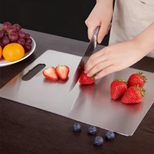 Flat pure titanium cutting board used for slicing fresh strawberries during everyday kitchen prep.