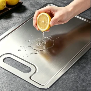 Grooved pure titanium cutting board used for preparing fresh chicken in the kitchen.