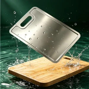 Grooved pure titanium cutting board being rinsed under running water in a kitchen sink.