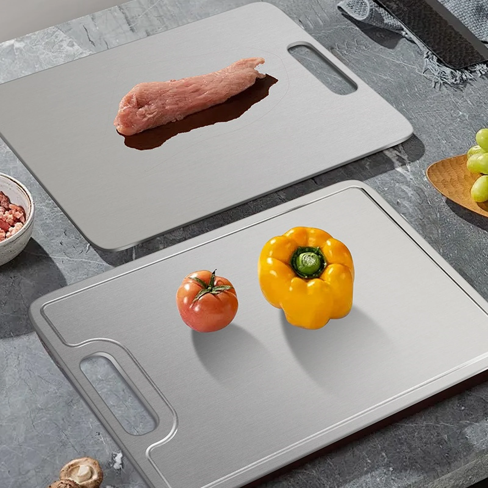 Lemon juice on a grooved pure titanium cutting board showing the raised perimeter around the prep surface.