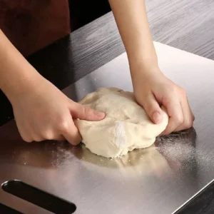 Pure titanium cutting board used as a work surface for kneading dough.