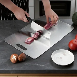 Pure titanium cutting board used for cutting fresh meat during meal preparation.