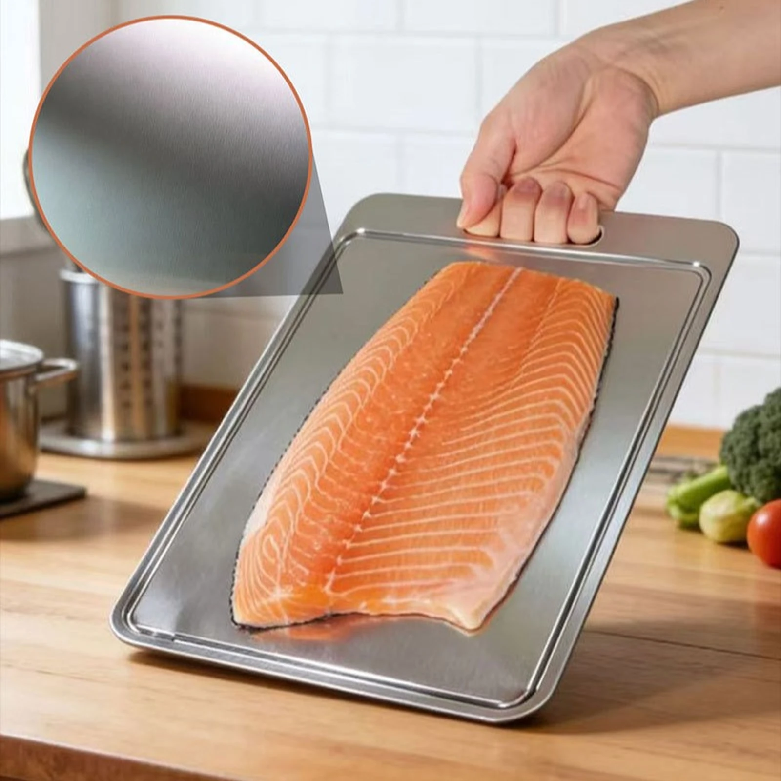 Grooved pure titanium cutting board holding a large salmon fillet in a kitchen.