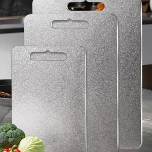 Three sizes of pure titanium cutting boards displayed in a modern kitchen.