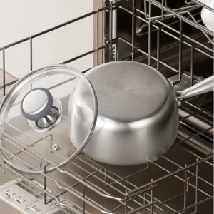 Titanium saucepan and glass lid placed in a dishwasher for cleaning