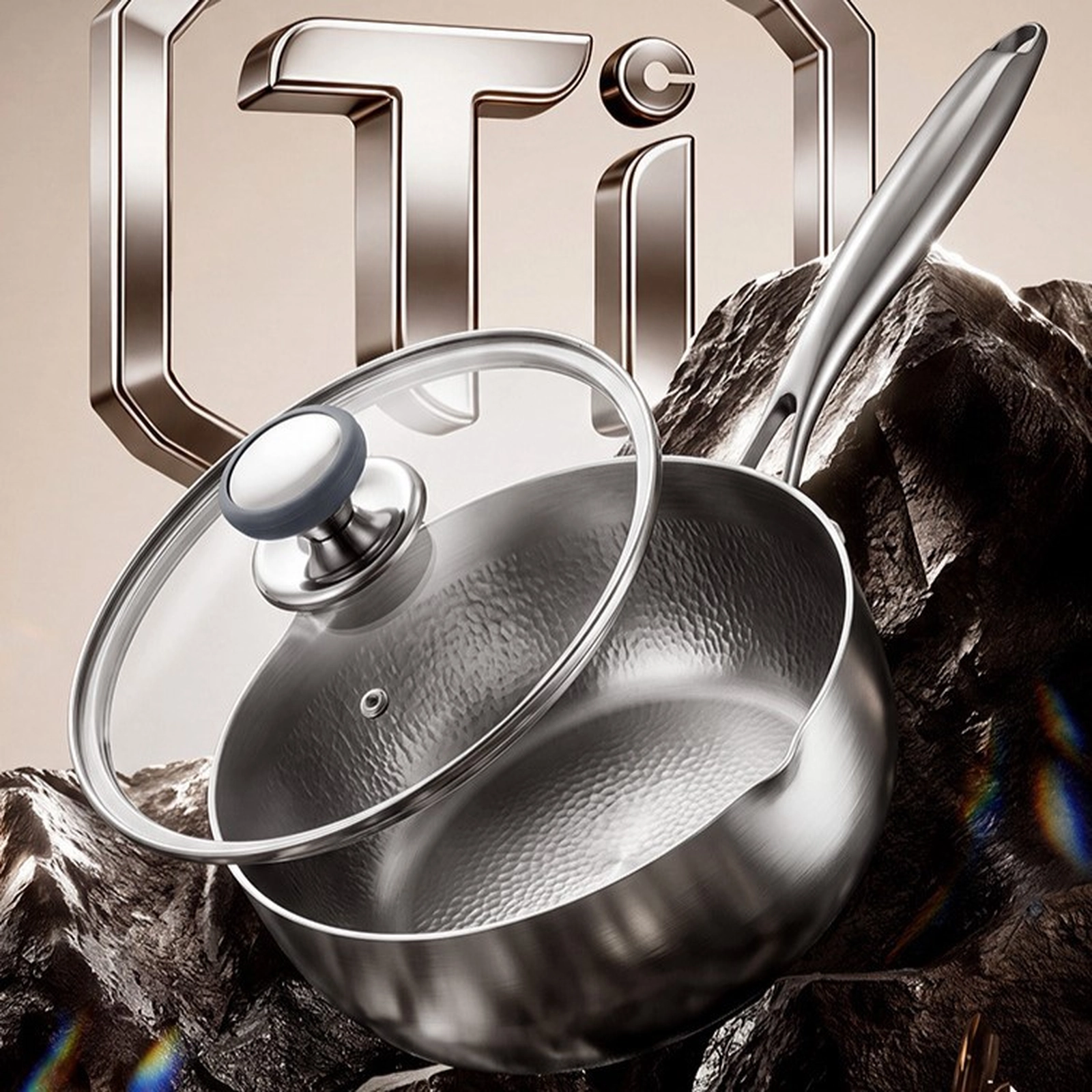Titanium saucepan with glass lid and polished stainless steel handle