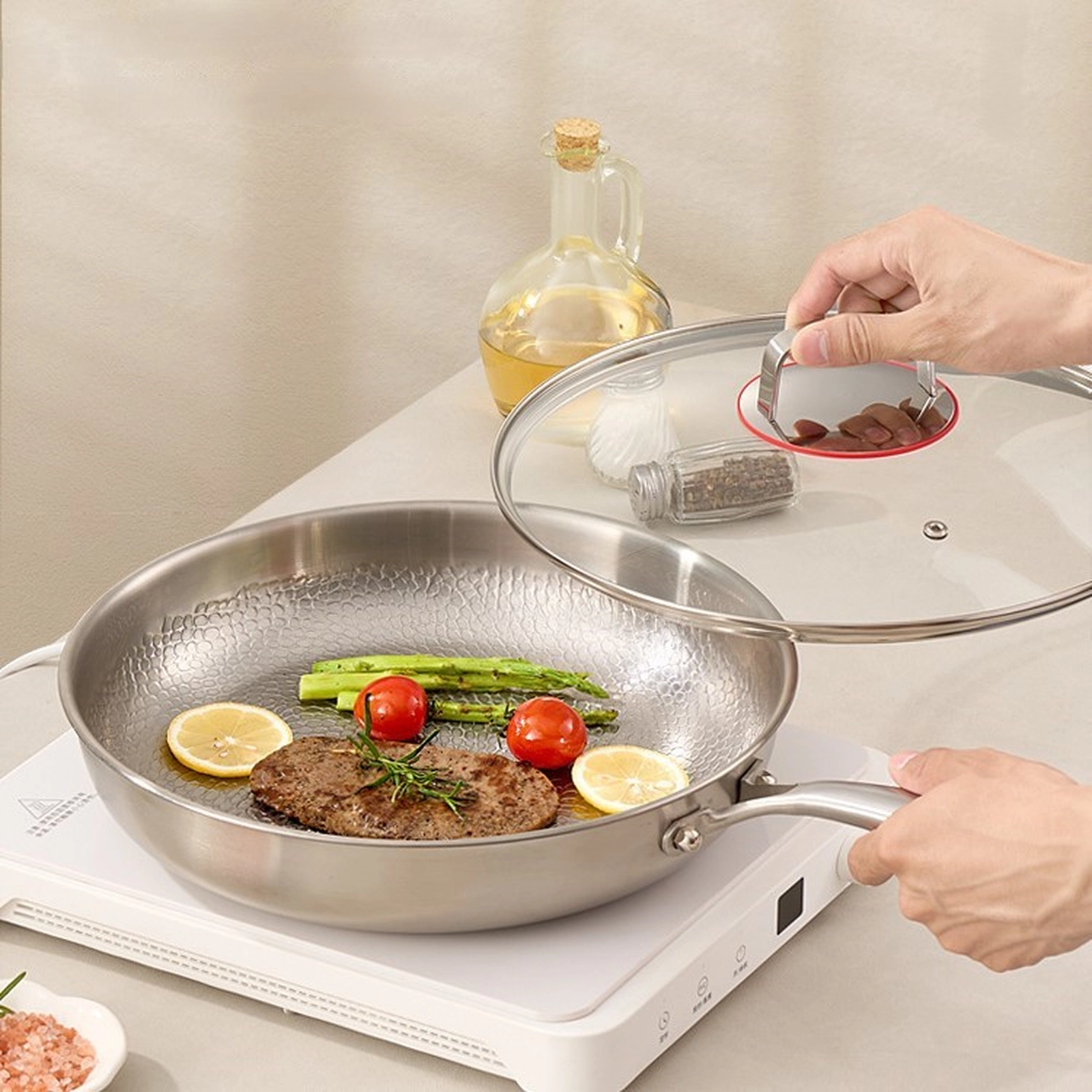 Titanium frying pan with glass lid cooking steak and vegetables